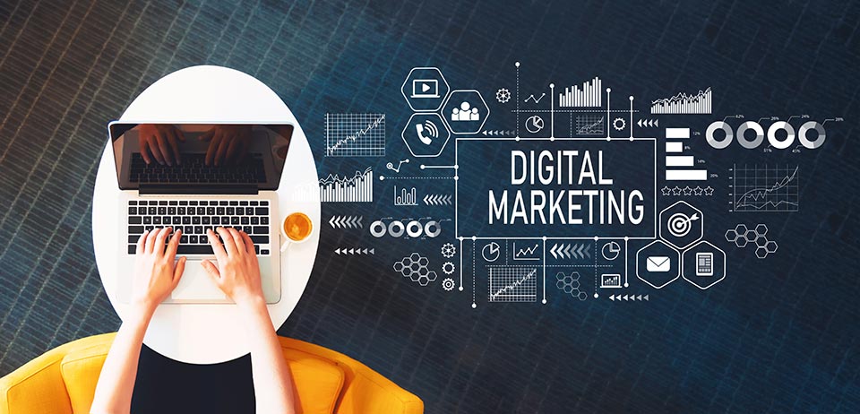 digital marketing message and symbols and someone typing on a laptop